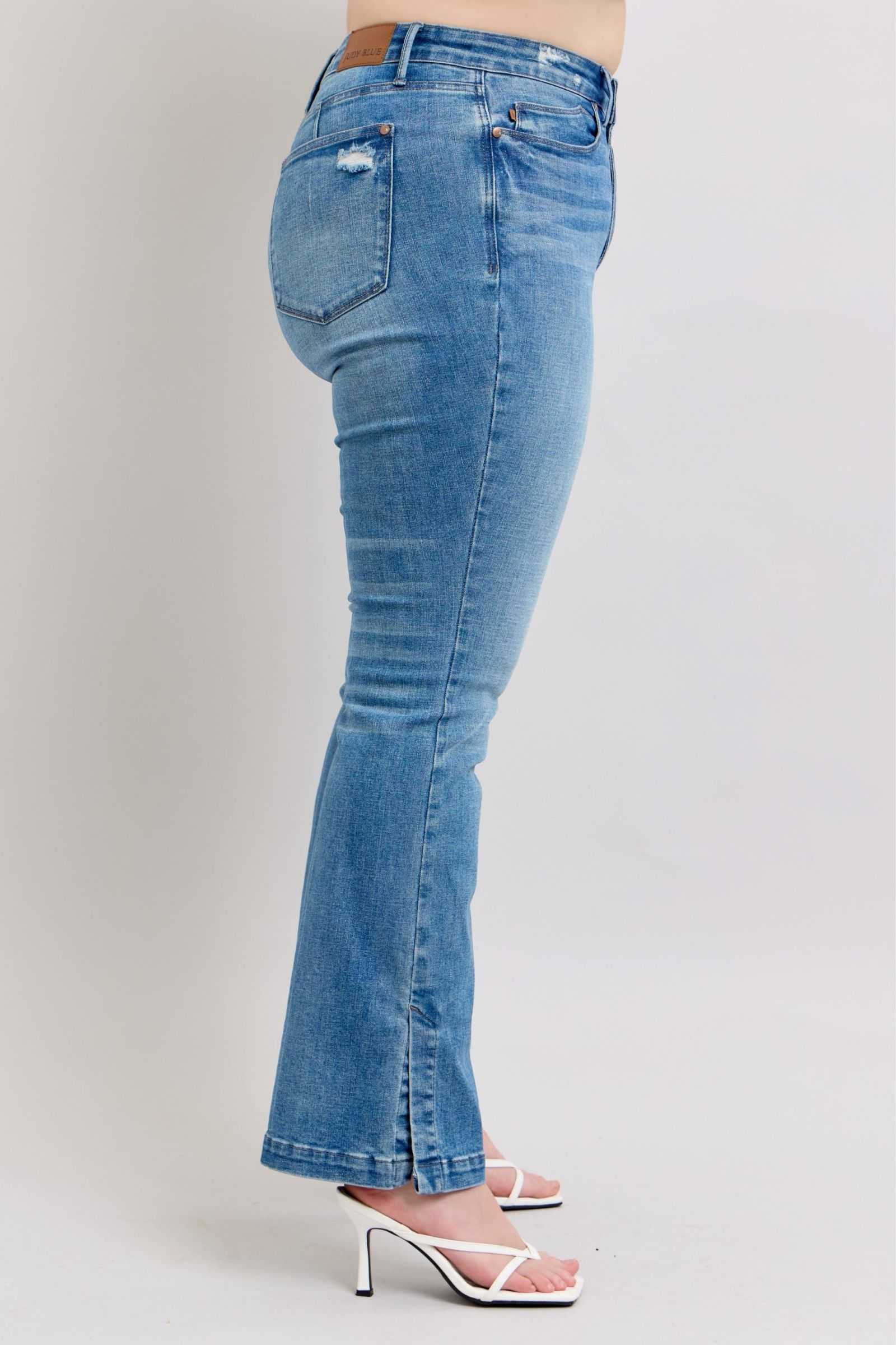 Judy Blue HW high-waisted tummy control vintage wash jeans with side slit and slim bootcut design.
