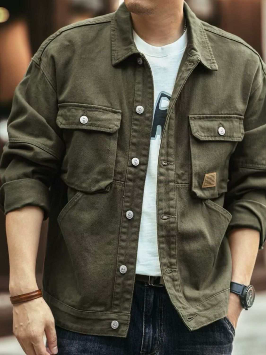 Men's washed collared neck cargo jacket in olive green with button details and chest pockets.