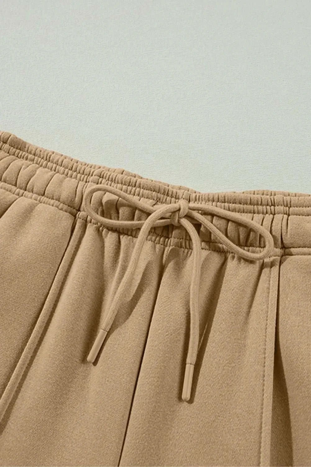 Drawstring wide leg pants with pockets in beige.