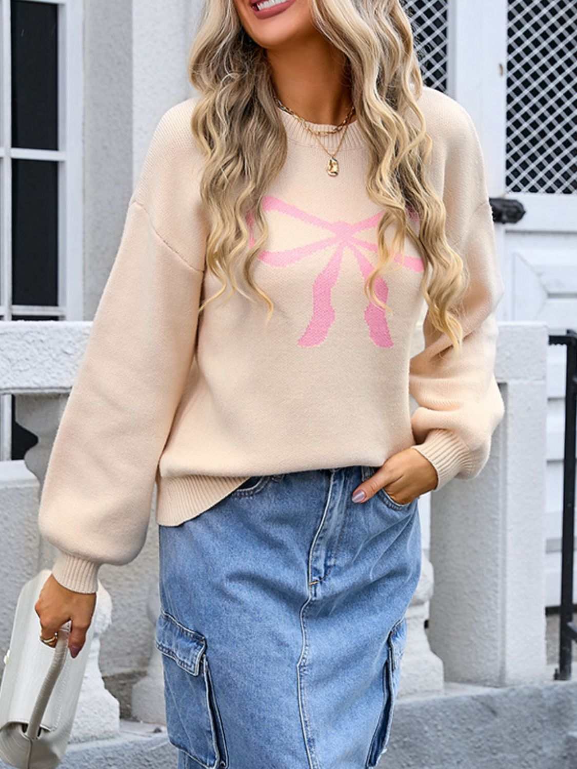 Angel Wings Bow Graphic Round Neck Long Sleeve Sweater in beige with pink bow design.