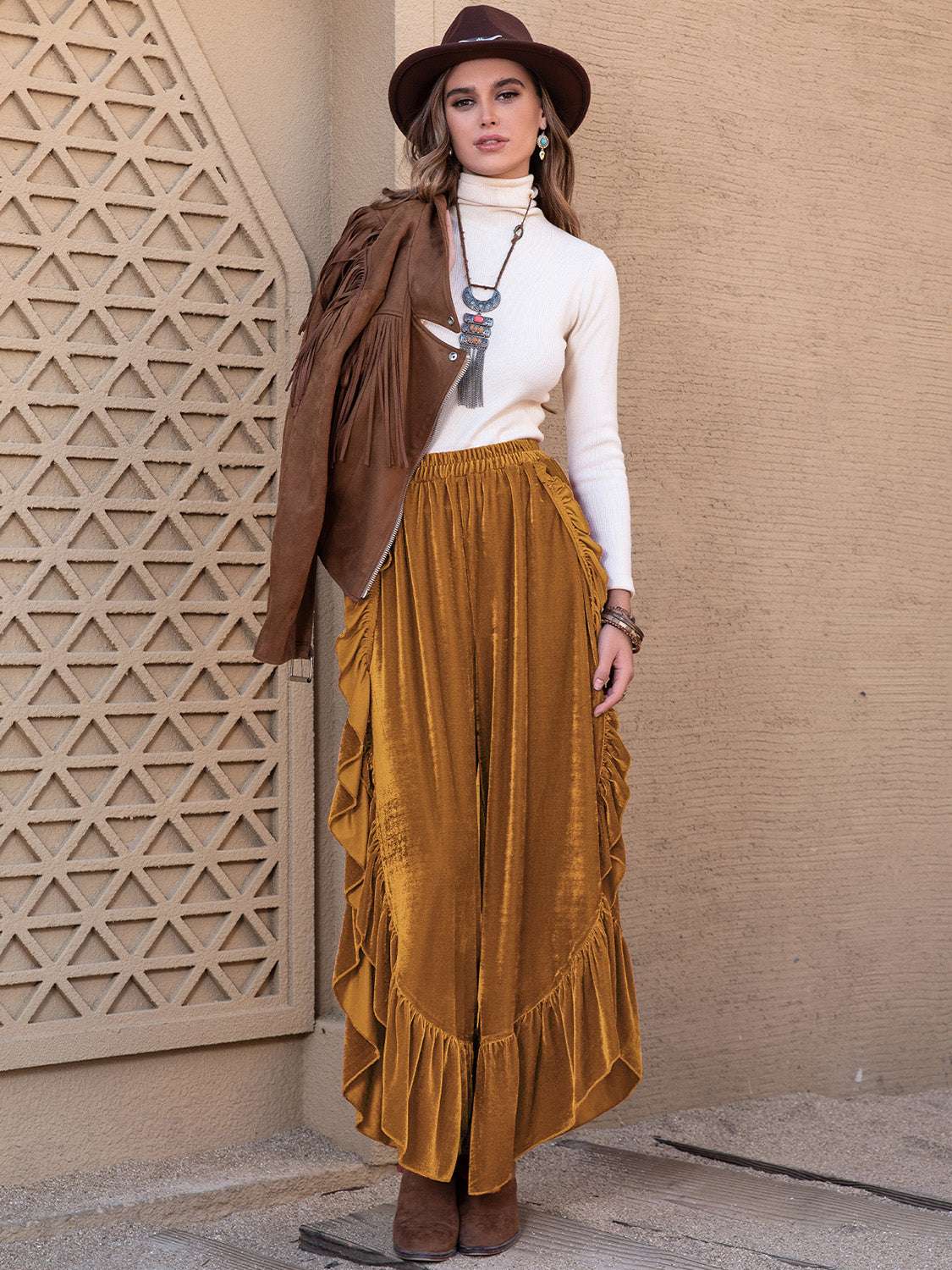 Slit Ruffled Wide Leg Pants in mustard, styled with a turtleneck and hat.