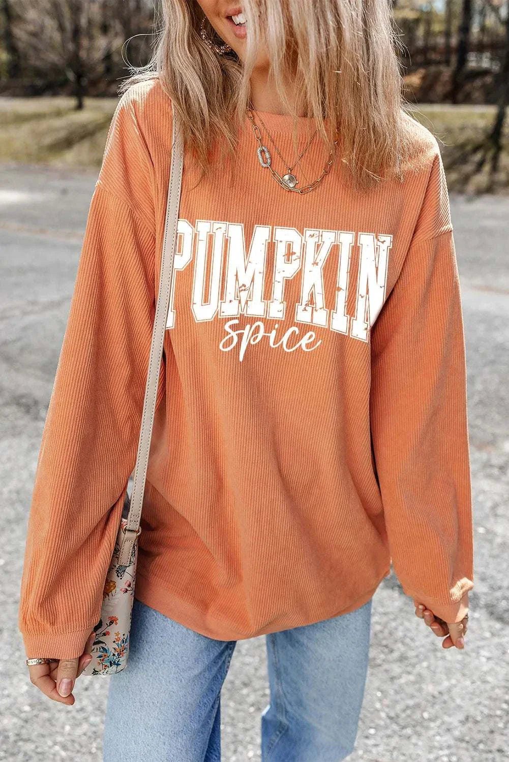 Orange letter graphic long sleeve sweatshirt with "Pumpkin spice" text and crew neck design