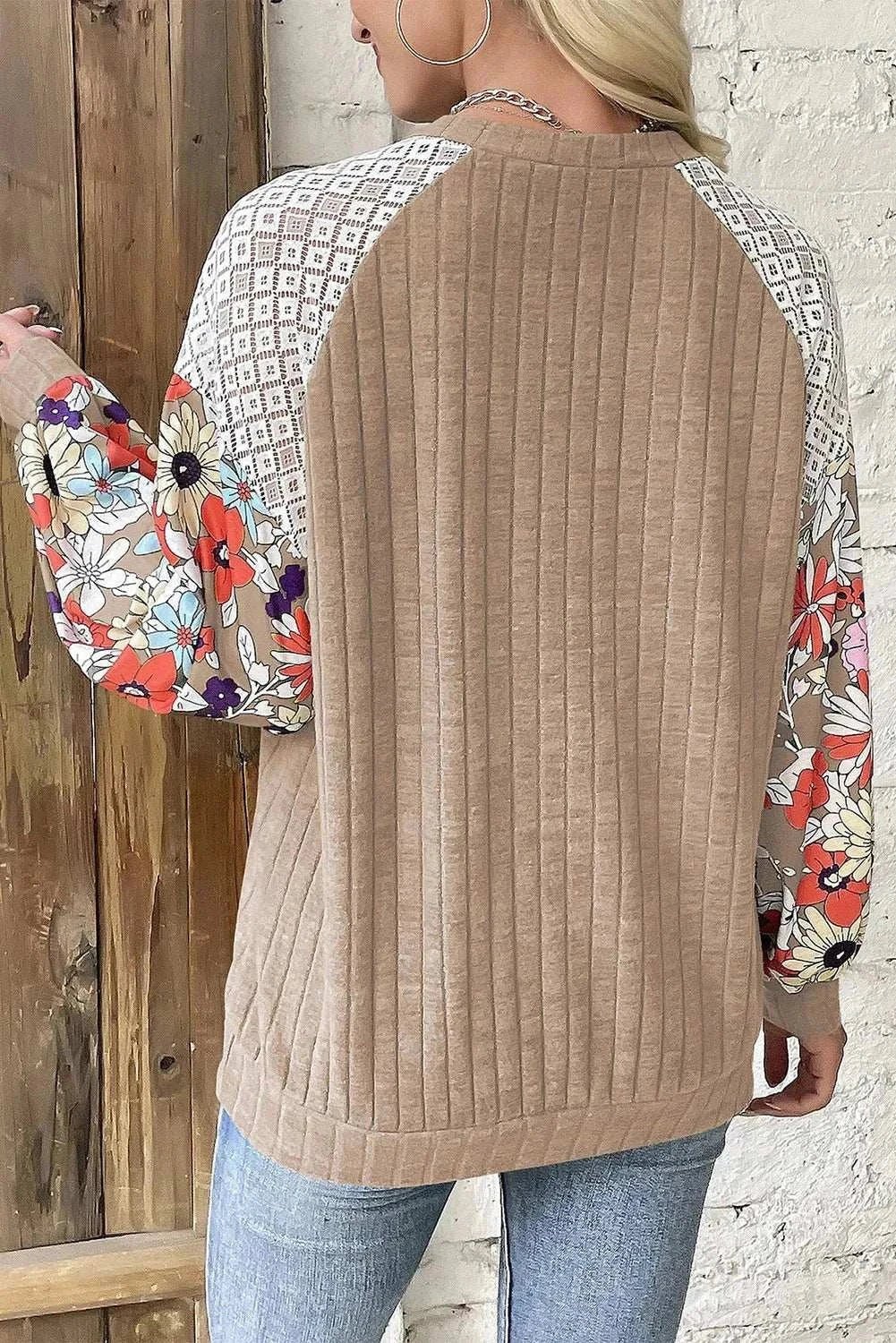 Printed round neck long sleeve top with floral and geometric patterns on sleeves, beige back, made from polyester and elastane.