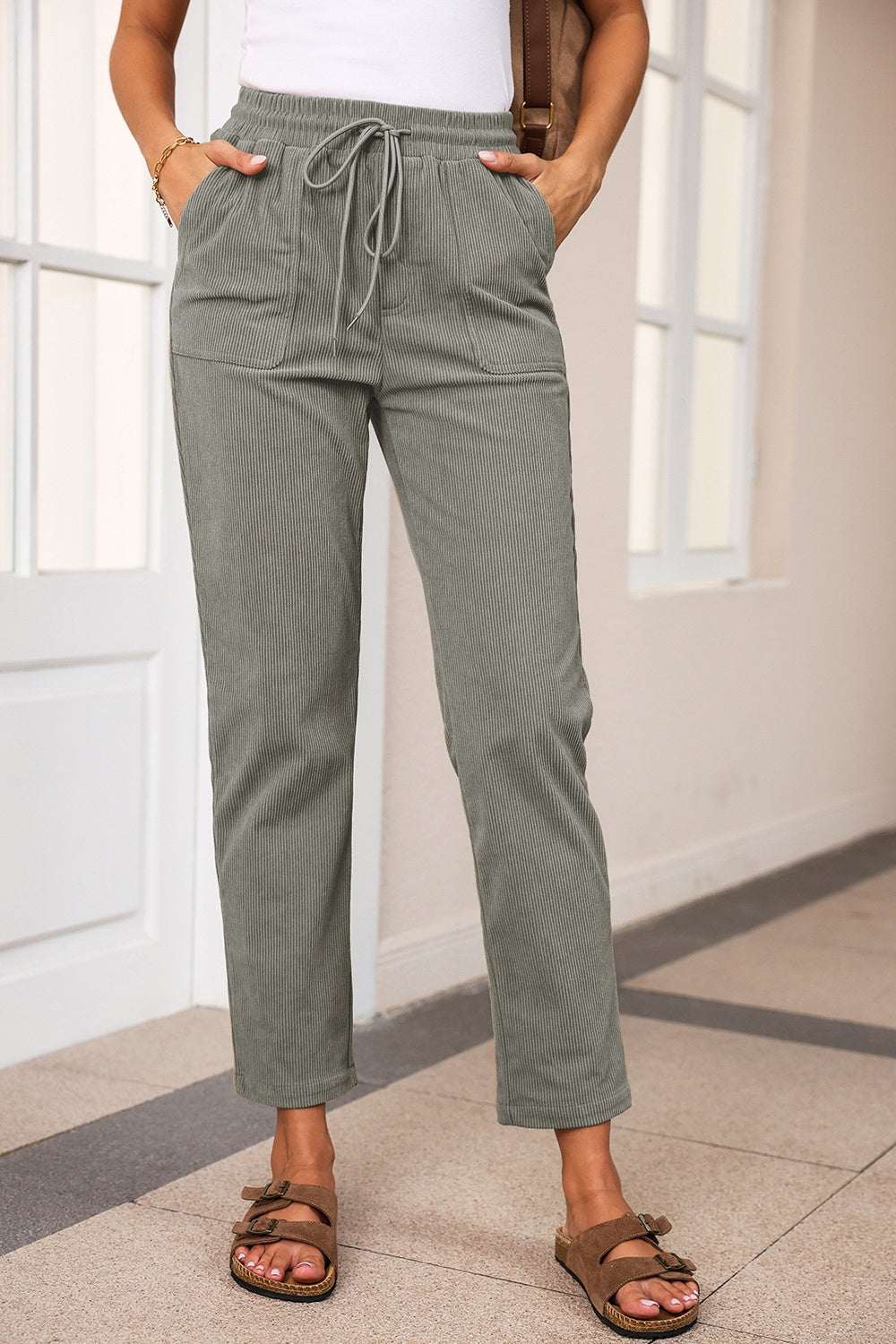 Drawstring straight pants with pockets in green, 100% polyester.