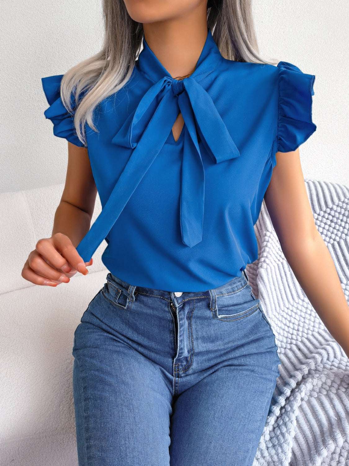 Tie Neck Cap Sleeve Blouse in blue, featuring tied design and slightly stretchy material.