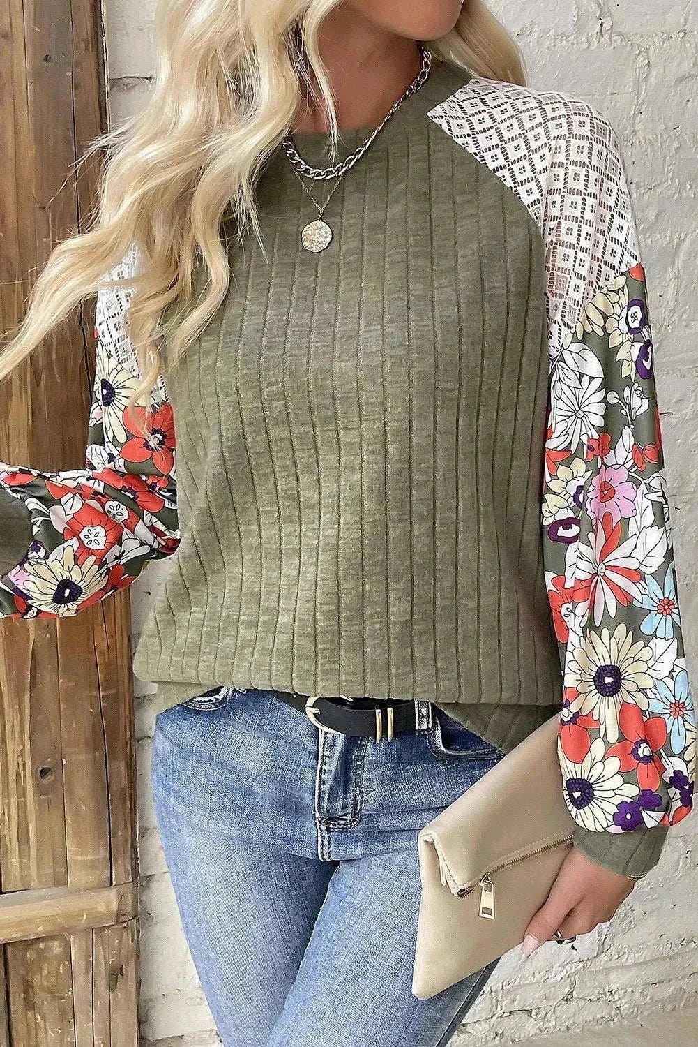 Printed round neck long sleeve top with floral sleeves and ribbed design.