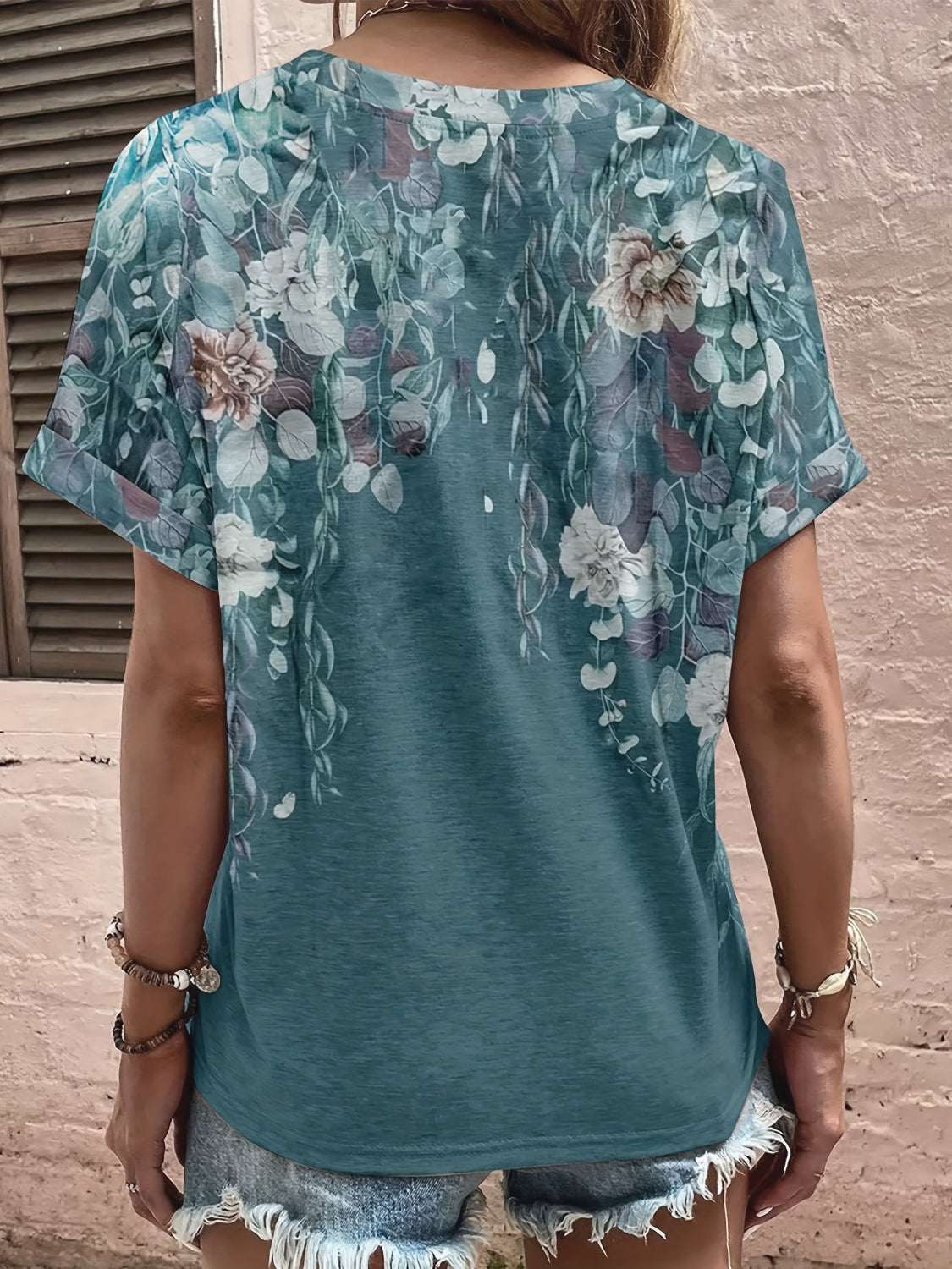 Full size printed notched short sleeve blouse in green with floral design.