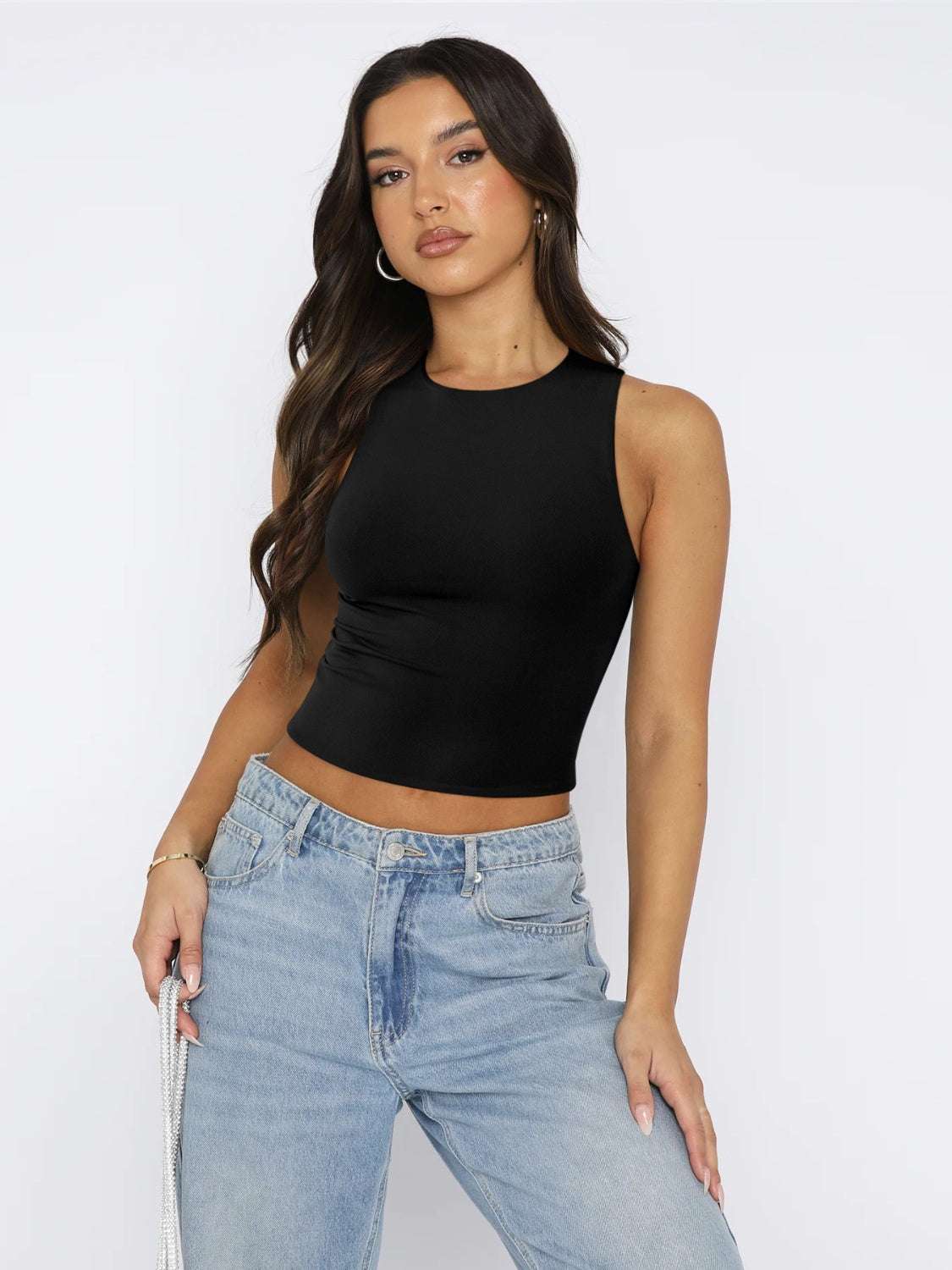 Round Neck Cropped Tank in black worn by a model with blue jeans.