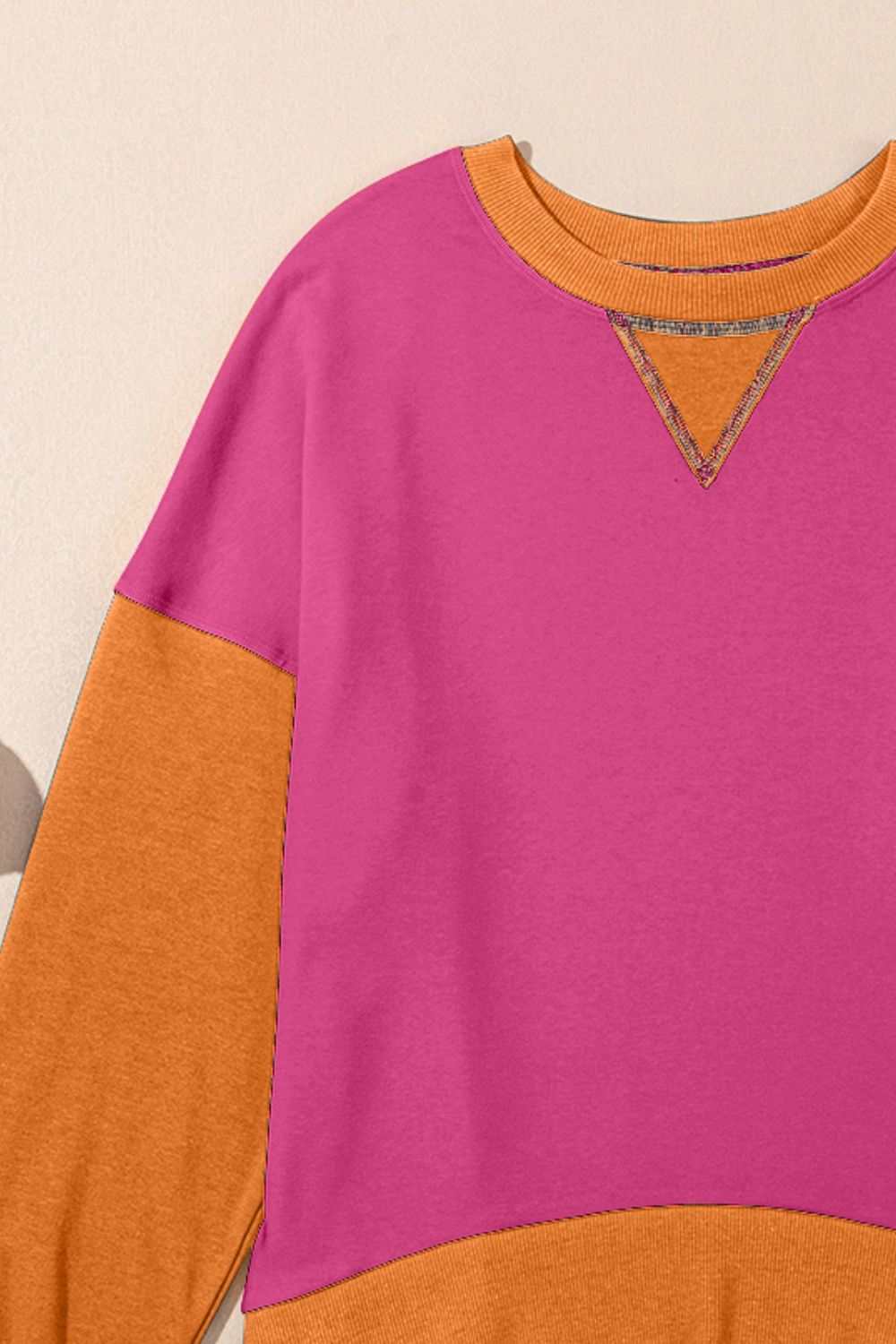 Contrast round neck long sleeve sweatshirt in pink and orange colors.