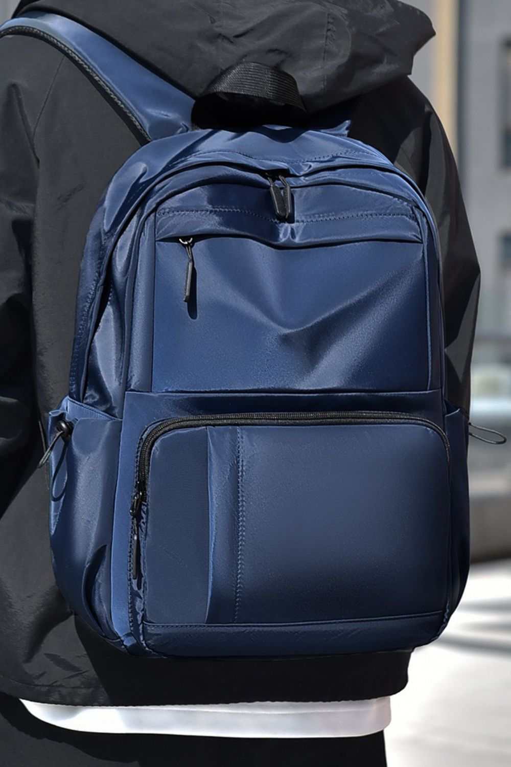 Large polyester multi-pockets solid color backpack.