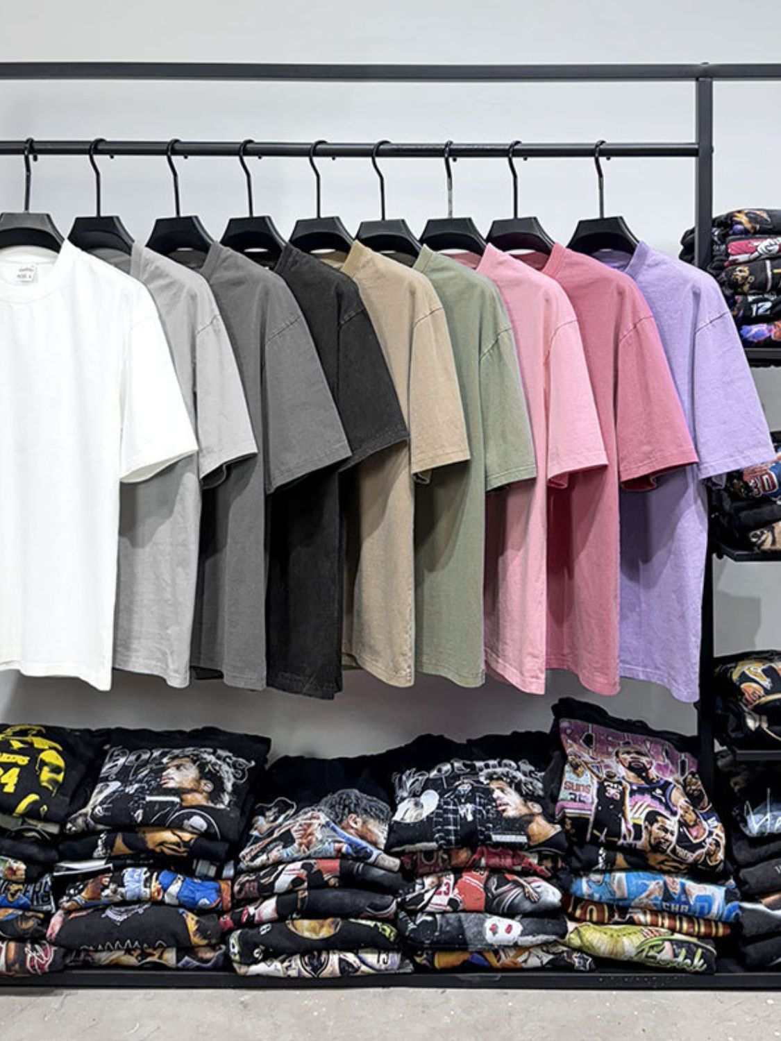 Men's full-size round neck washed t-shirts in various colors on a rack.