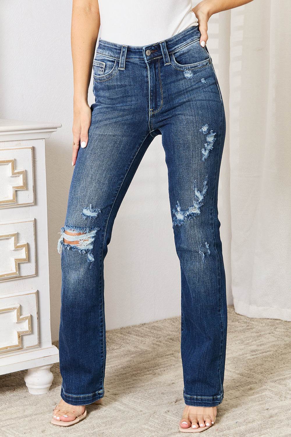 Judy Blue mid-rise distressed bootcut jeans with a hand-sanded finish and slight stretch.