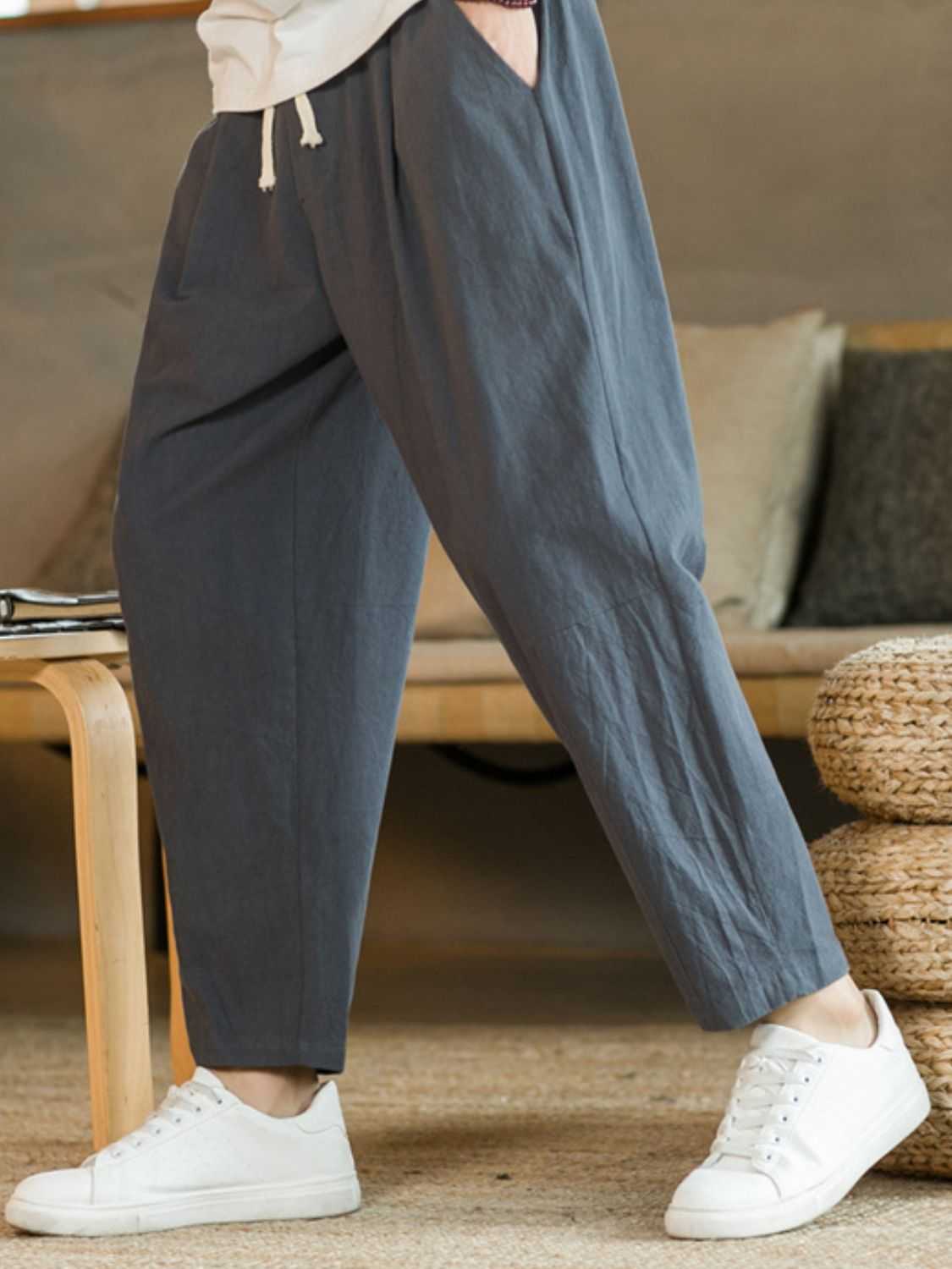 Plus size drawstring pants with pockets in gray, made of cotton and flax, shown with white sneakers.