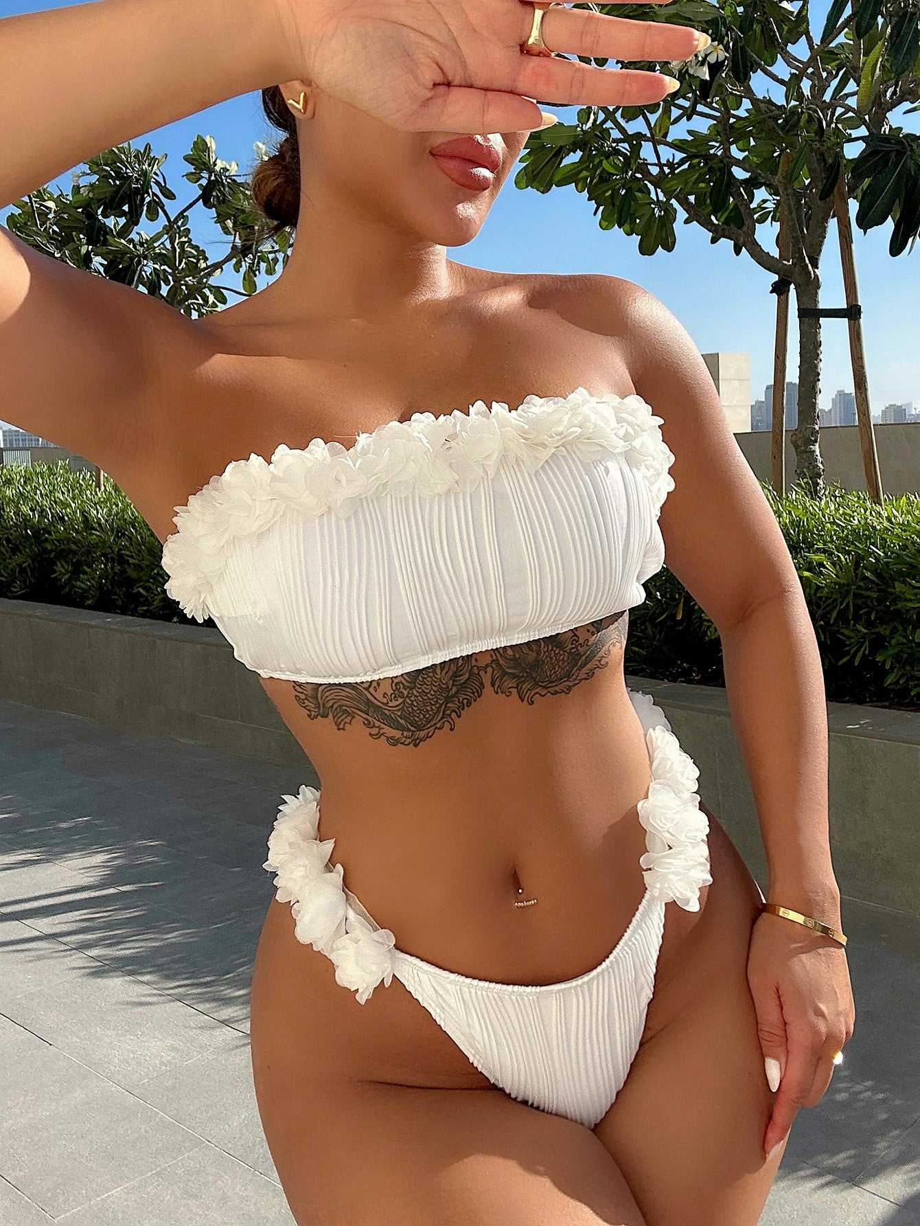 Applique tie back two-piece bikini set in solid white with removable padding and low waist design.
