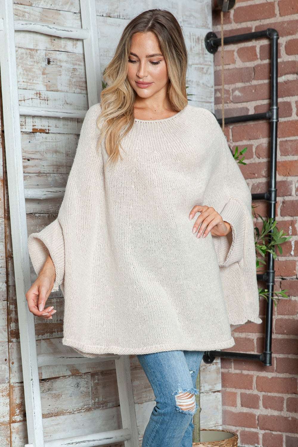 Round neck batwing sleeve sweater in beige, slightly stretchy, 100% polyester.
