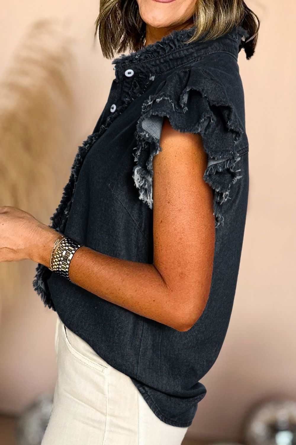 Ruffled denim shirt with button down front and raw hem.