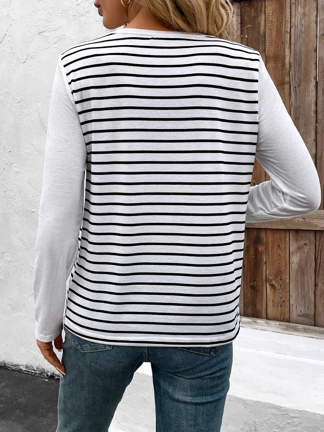 Decorative button striped round neck long sleeve T-shirt with black and white stripes, slightly stretchy polyester blend.
