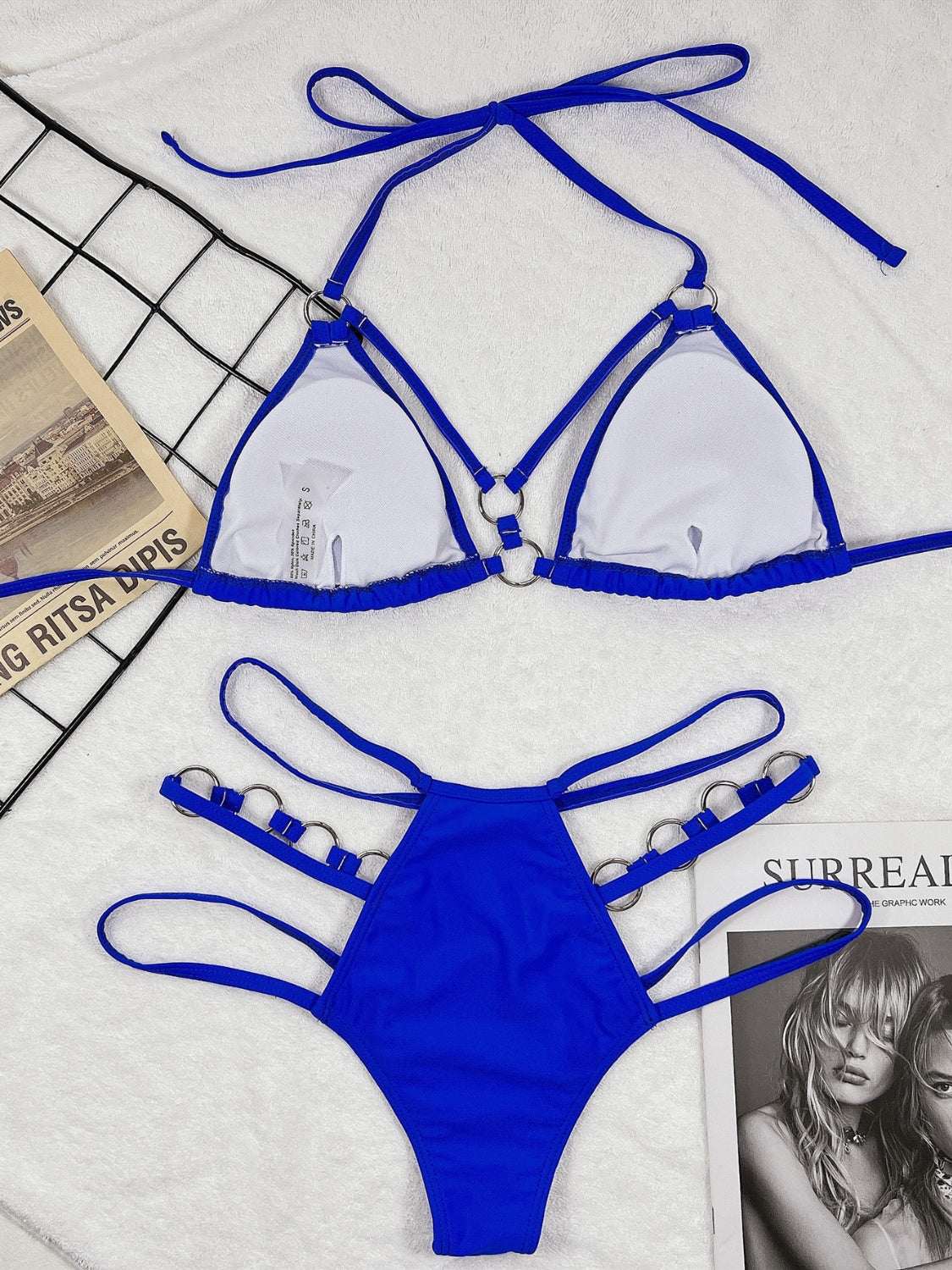 Cutout halter neck two-piece bikini set in blue with removable padding and slight stretch.