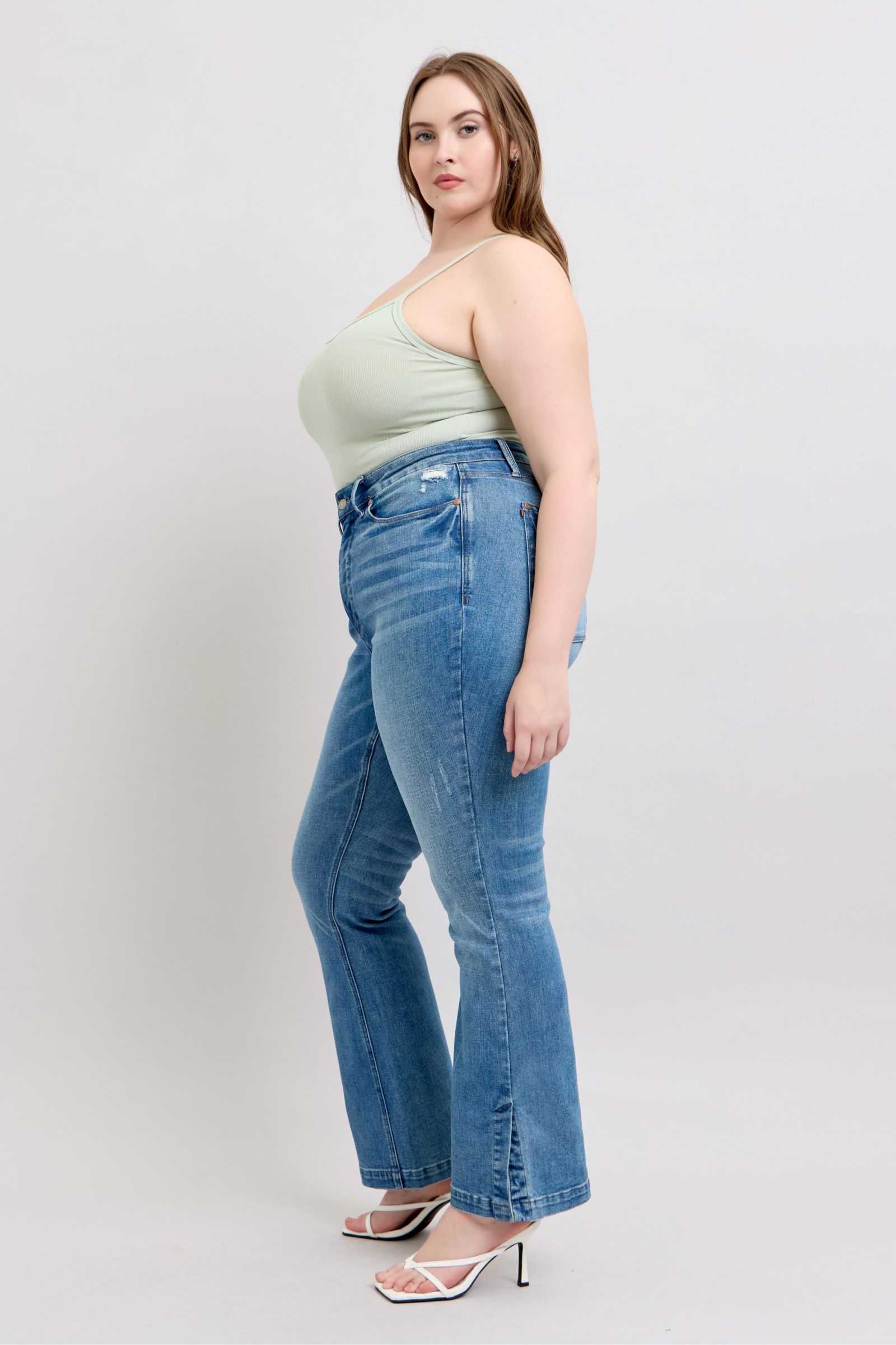 Judy Blue HW Tummy Control Vintage Wash Side Slit Slim Boot Jeans on a model showcasing fit and style.