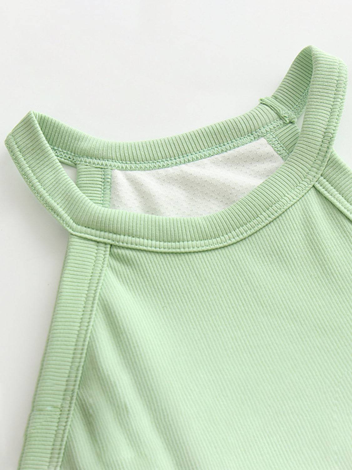 Ribbed Grecian neck cropped tank with chest pads in green.