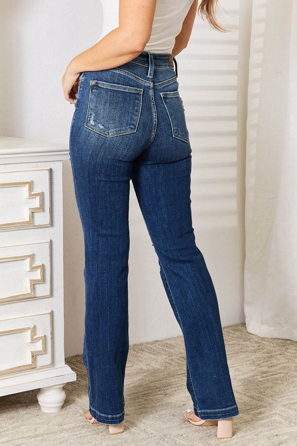 Judy Blue Full Size Mid Rise Bootcut Jeans with distressed detailing and stretch fabric, rear view.
