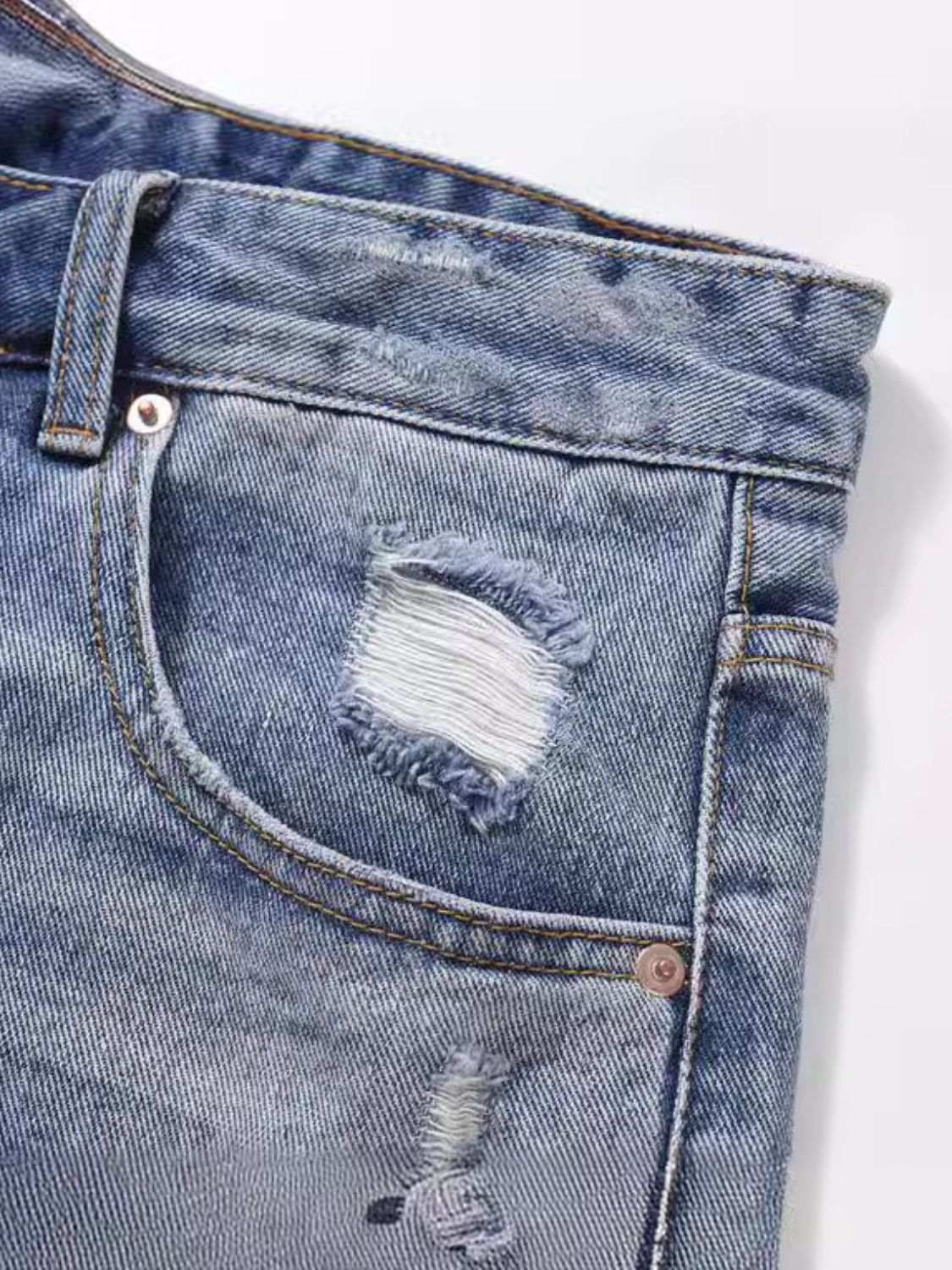 Men's distressed denim Bermuda shorts with frayed detailing and classic pocket design.