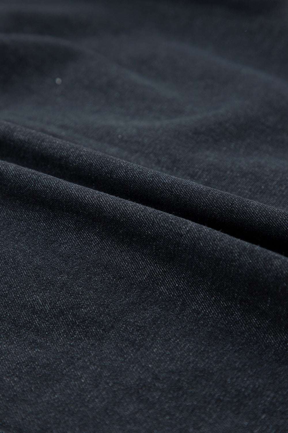 Denim fabric close-up of Button Down Raw Hem Ruffled Denim Shirt.