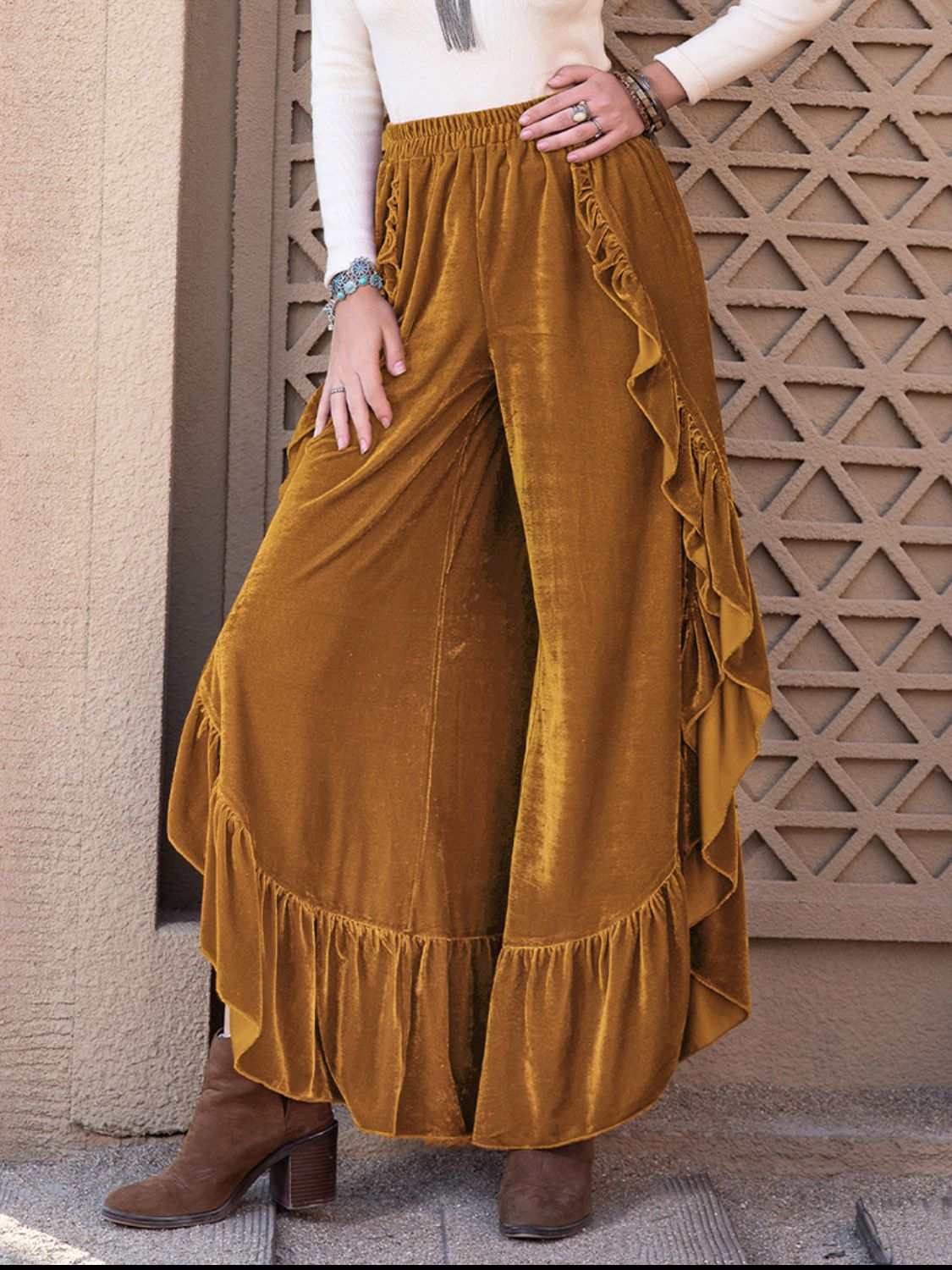 Slit ruffled wide leg pants in mustard yellow worn by model.