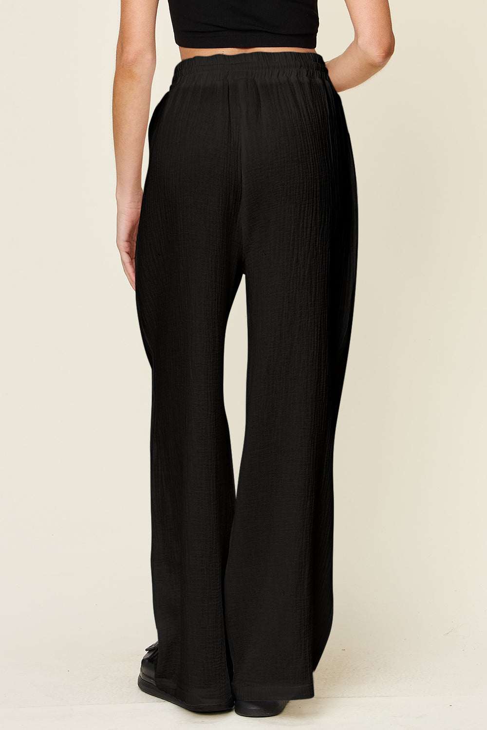 Wide leg black drawstring pants made of 100% cotton.