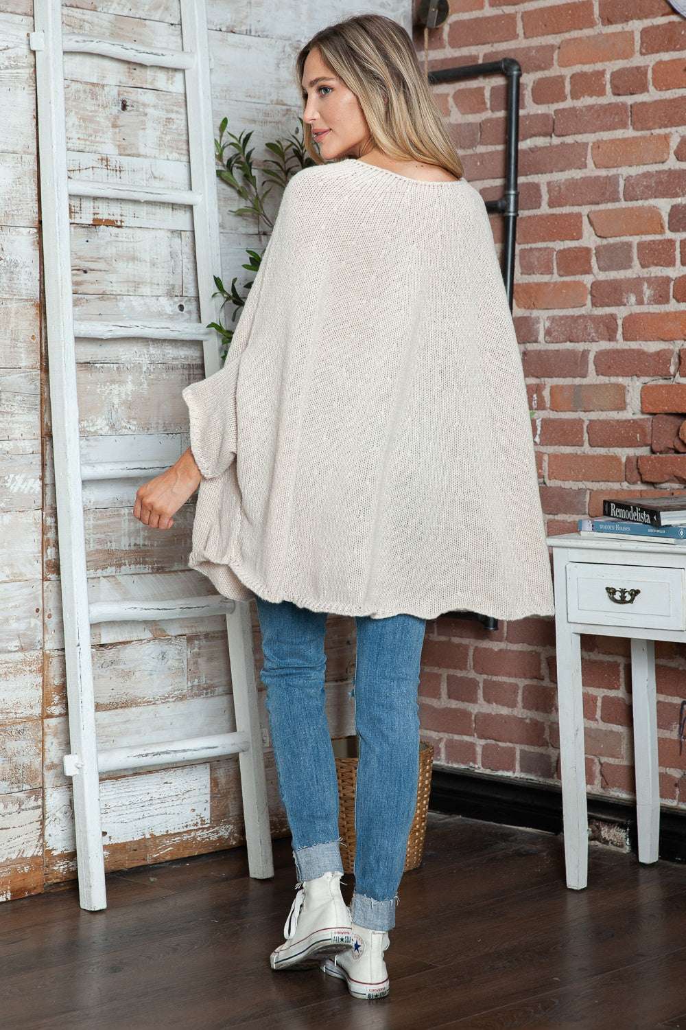 Round neck batwing sleeve sweater in light beige color.